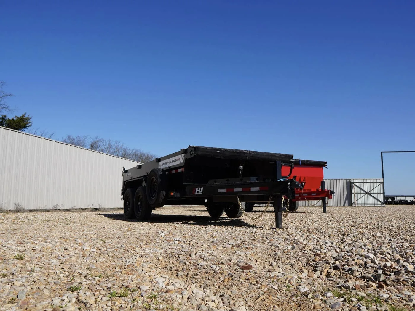 PJ Dump Trailer with short sides on a gravel road