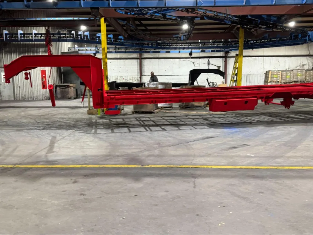 a Red Load Trail Gooseneck Trailer on a assembly line