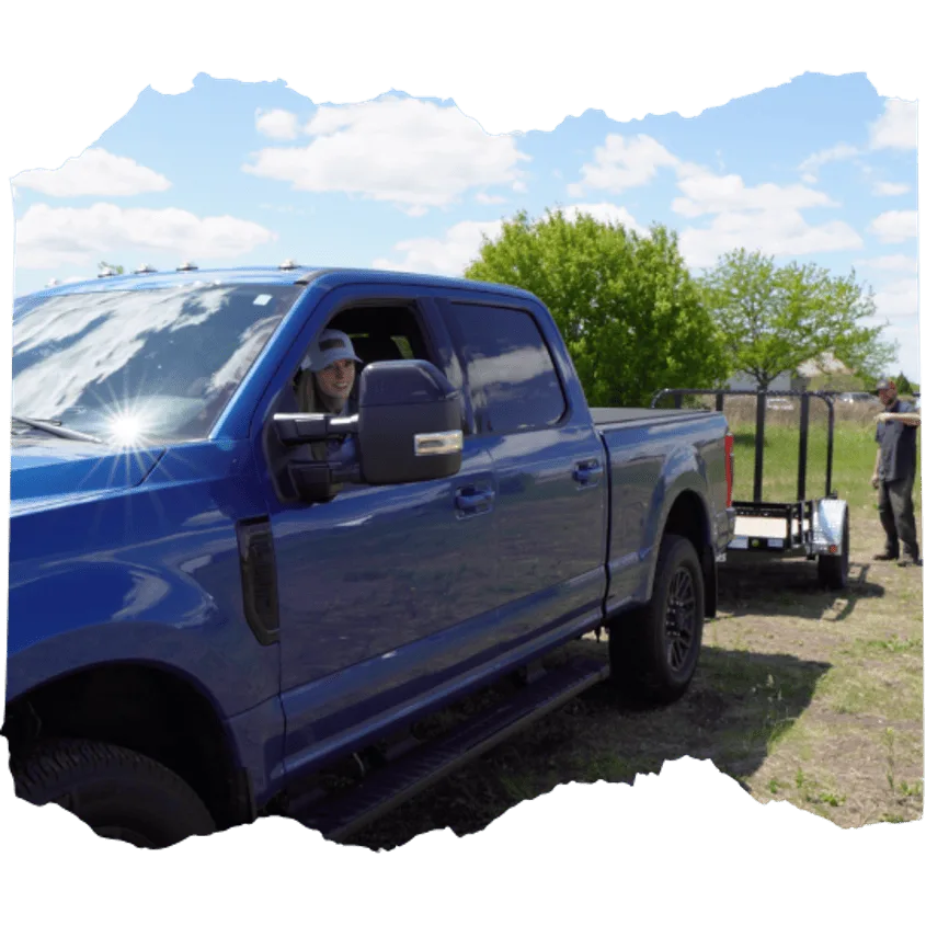 Person in truck learning how to hitch a trailer