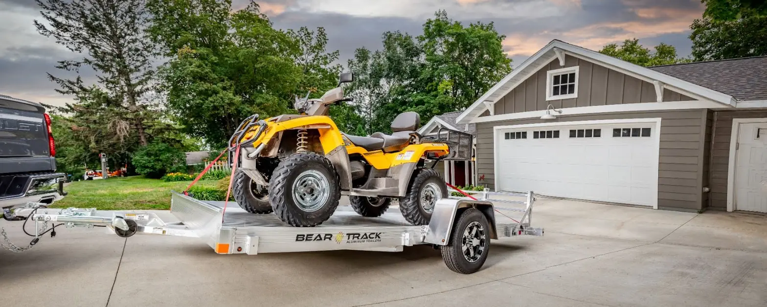 Bear Track dealer — Bear Track trailer loaded with an ATV